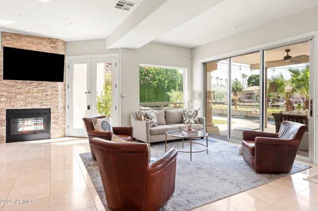 a dining room with furniture a chandelier and wooden floor