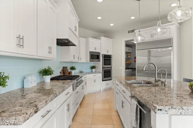 a view of a dining room with furniture and a chandelier