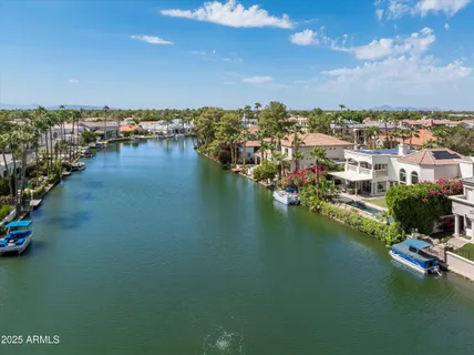 an aerial view of residential houses with outdoor space and swimming pool