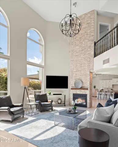 a living room with furniture a flat screen tv and a large window