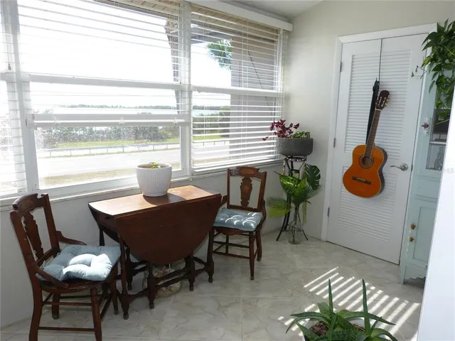 a dining room with furniture and a window