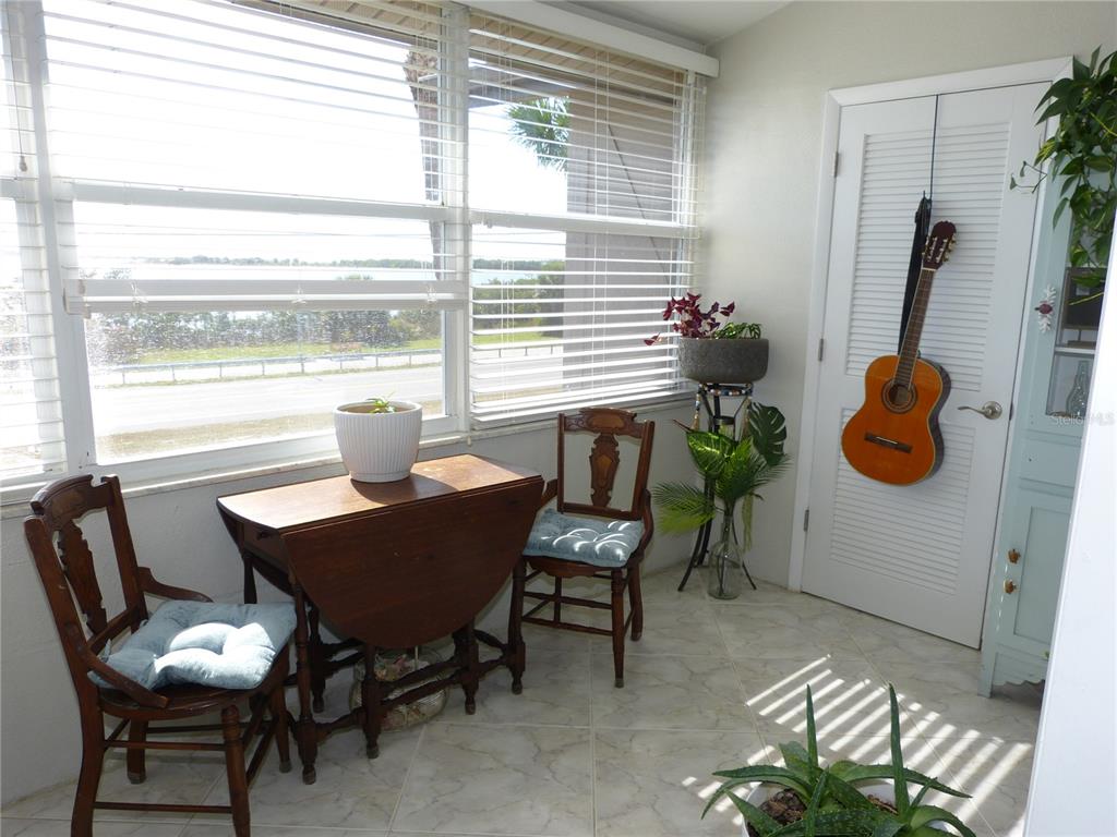 2 Causeway Boulevard, Unit 206 Dunedin, FL 34698 - Photo 16 of 26 a dining room with furniture and a window