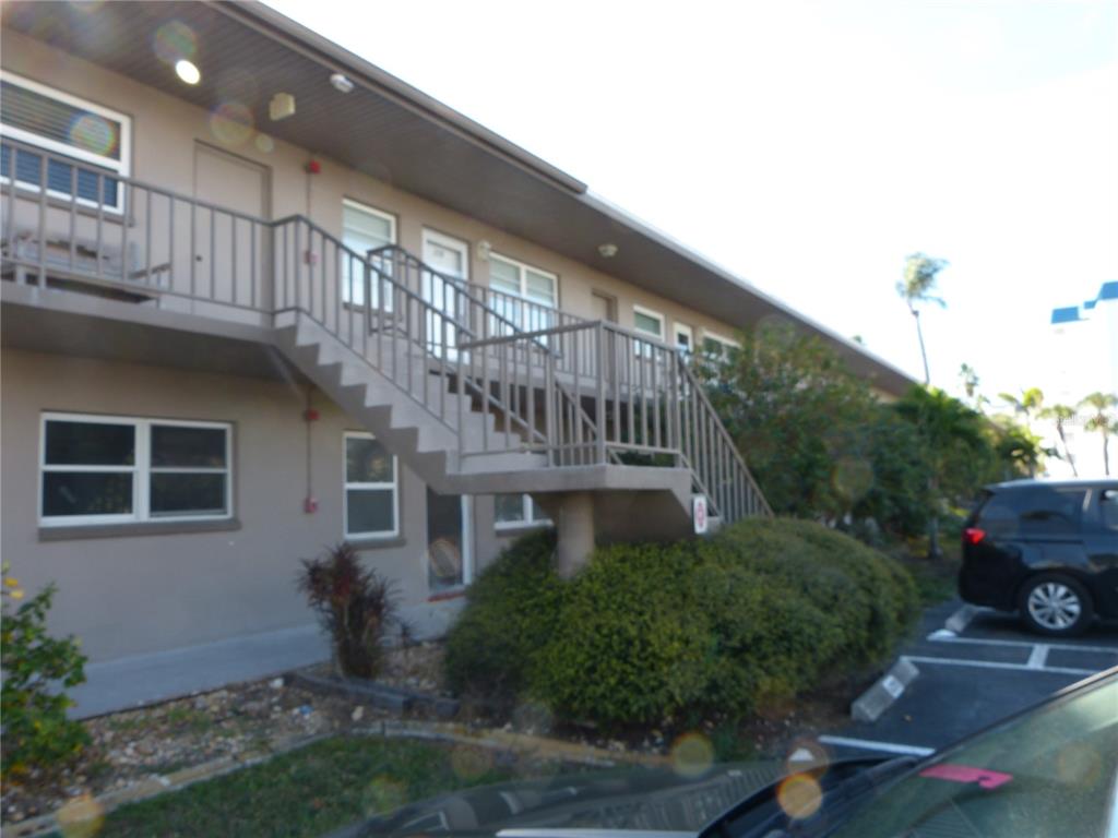 2 Causeway Boulevard, Unit 206 Dunedin, FL 34698 - Photo 2 of 26 a front view of a house with a garden