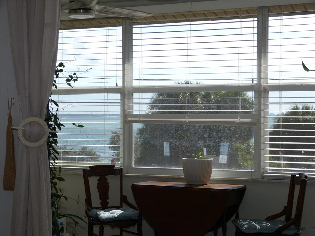 2 Causeway Boulevard, Unit 206 Dunedin, FL 34698 - Photo 21 of 26 a view of a dining room with furniture and windows