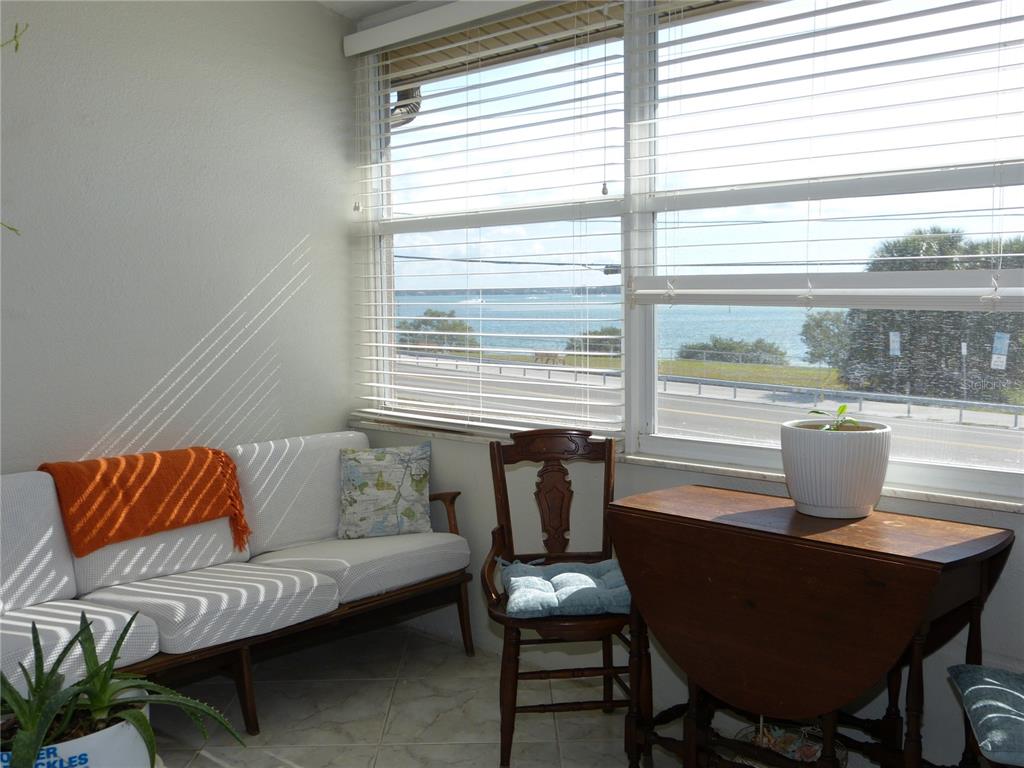 2 Causeway Boulevard, Unit 206 Dunedin, FL 34698 - Photo 22 of 26 a living room with furniture and a window