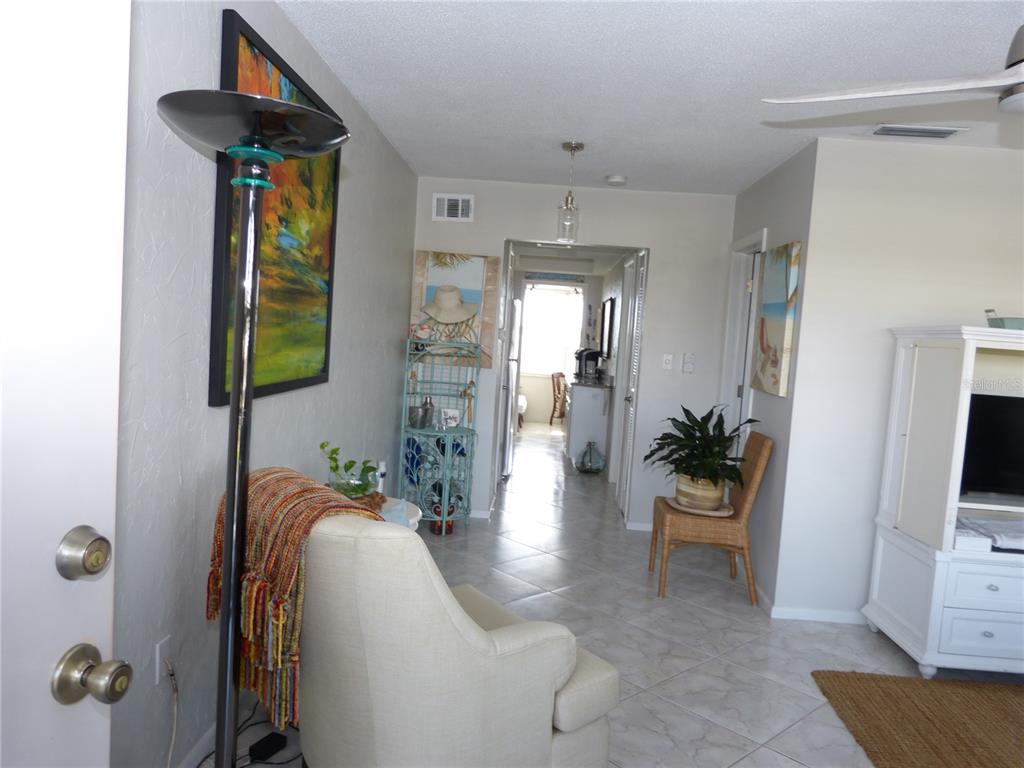 2 Causeway Boulevard, Unit 206 Dunedin, FL 34698 - Photo 5 of 26 a living room with furniture and a flat screen tv