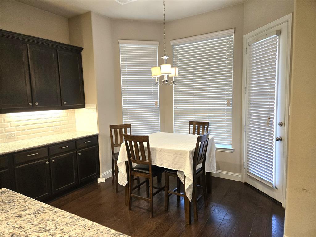 680 Wingate Road Coppell, TX 75019 - Photo 11 of 23 a view of a dining room with furniture and wooden floor