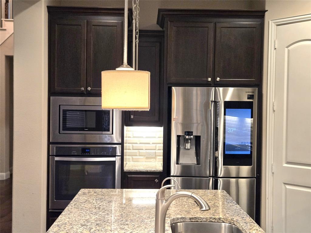 680 Wingate Road Coppell, TX 75019 - Photo 13 of 23 a kitchen with a refrigerator and a stove top oven