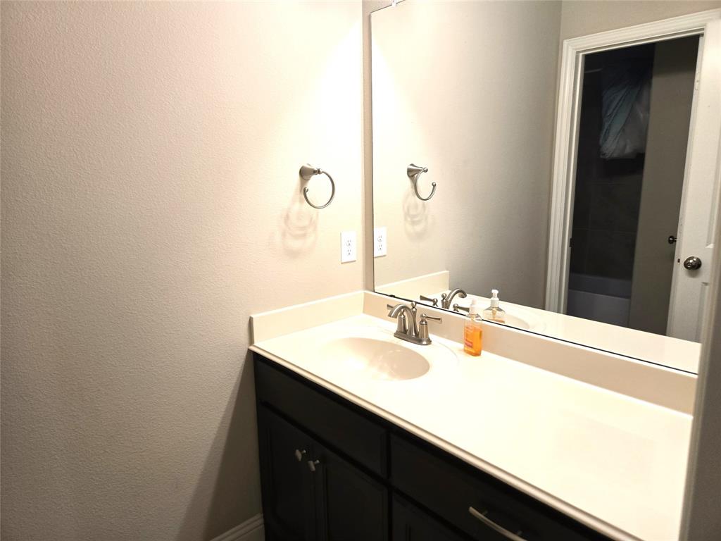 680 Wingate Road Coppell, TX 75019 - Photo 19 of 23 a bathroom with a sink and a mirror