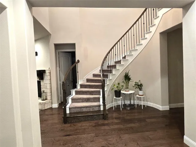 a view of entryway and hall with wooden floor