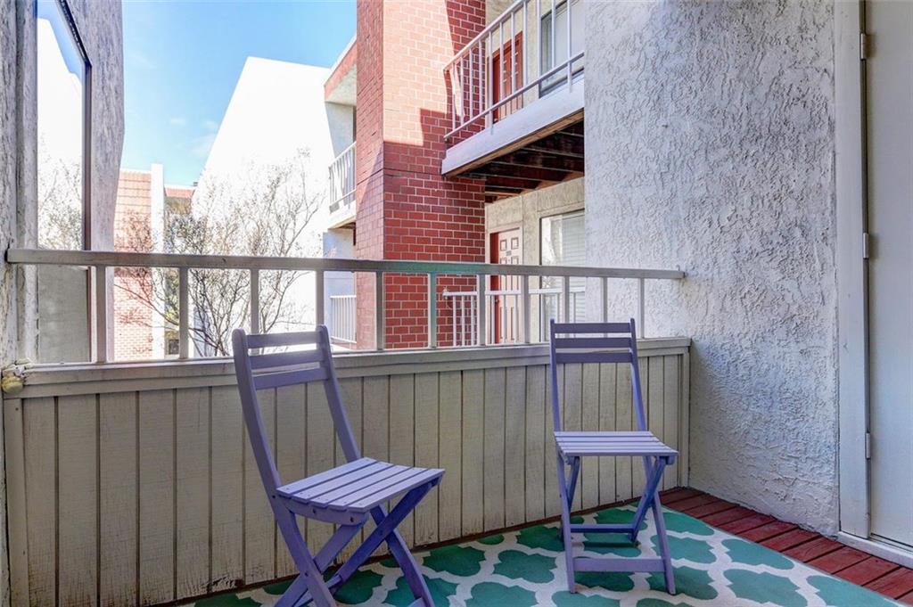 3115 Helms Street, Unit 204 Austin, TX 78705 - Photo 9 of 13 A cozy outdoor balcony, perfect for morning coffee or evening relaxation, overlooks the neighborhood.