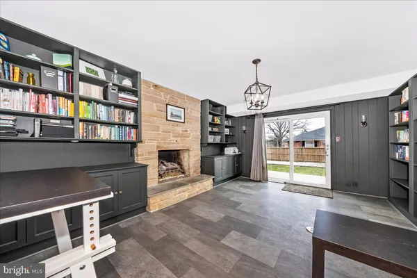 a view of an empty room with furniture and a fireplace