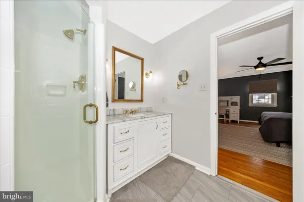 a bathroom with a sink a light fixture and a mirror