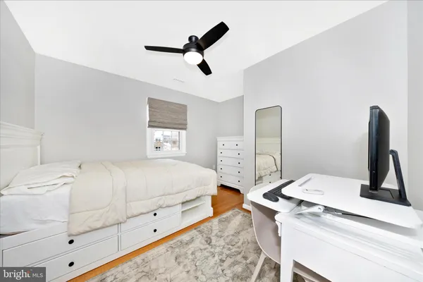 a bedroom with a bed and a large mirror