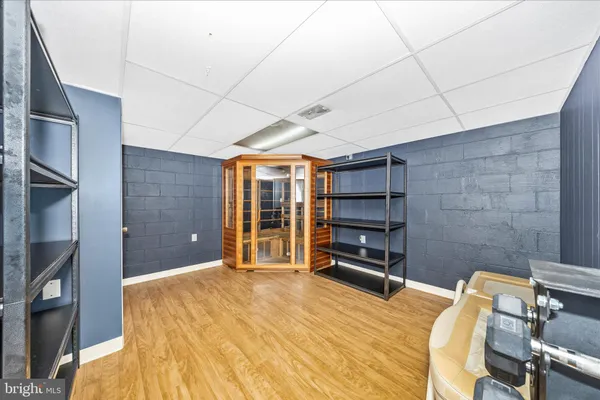 a bedroom with a bed and gym equipment