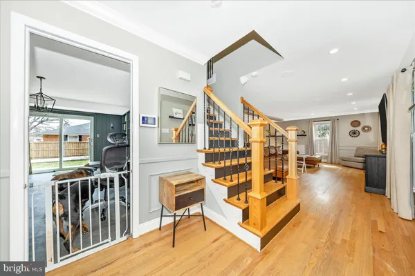 a living room with lots of furniture and a wooden floor