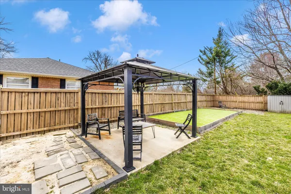 a view of a backyard with a garden and deck