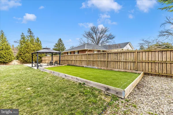 a swimming pool with outdoor seating and yard