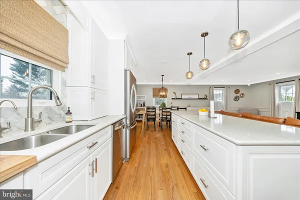 a large kitchen with stainless steel appliances kitchen island a large counter space and a window