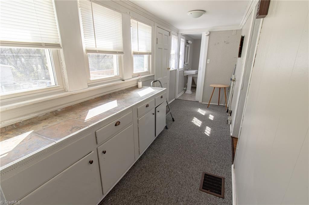 319 Cherry Street Eden, NC 27288 - Photo 11 of 22 laundry area with cabinet storage and folding space