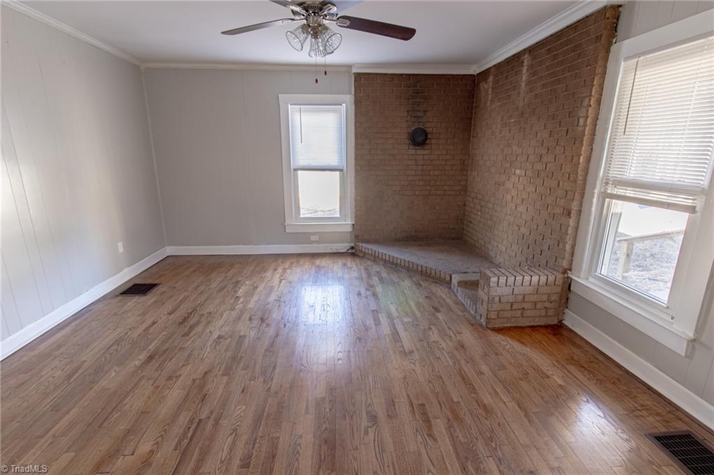 319 Cherry Street Eden, NC 27288 - Photo 3 of 22 large living room with beautiful hardwoods, large hearth and flue ready for a wood stove or big screen tv, great place for plants