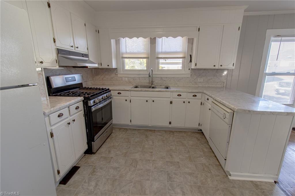 319 Cherry Street Eden, NC 27288 - Photo 5 of 22 nice bright kitchen with new flooring and gas range, refrigerator and dishwasher, open to dining room