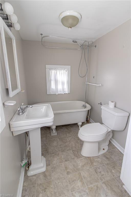 319 Cherry Street Eden, NC 27288 - Photo 10 of 22 downstairs bath with claw foot tub, equipped with shower