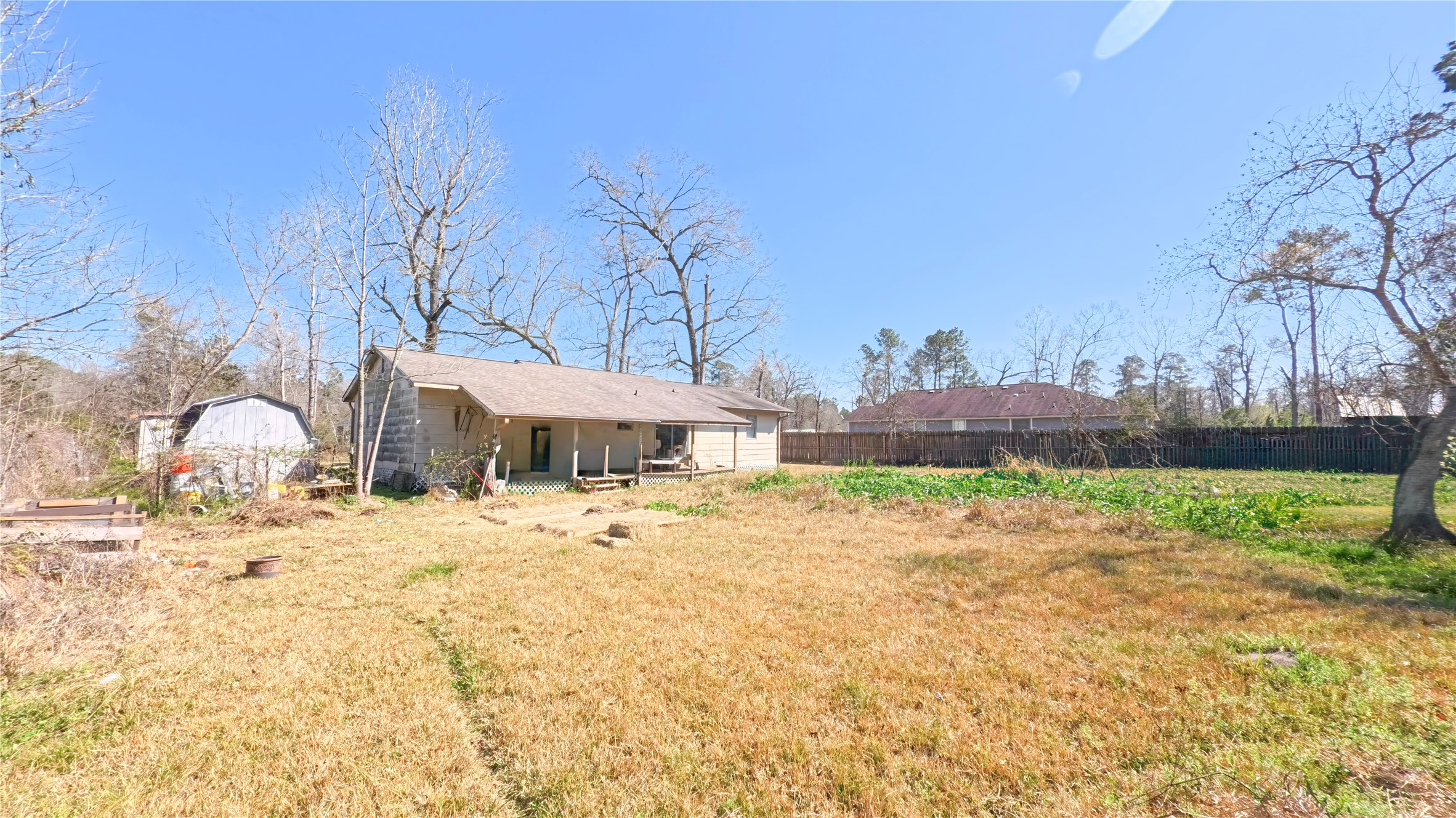 14452 Half Circle Splendora, TX 77372 - Photo 12 of 13 a wooden bench sitting in middle of the yard