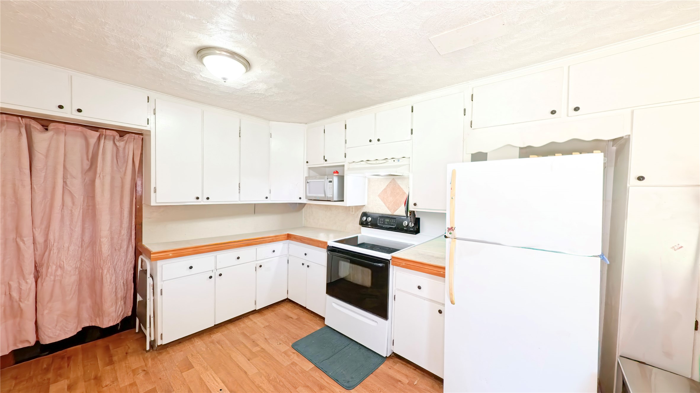 14452 Half Circle Splendora, TX 77372 - Photo 9 of 13 a kitchen with granite countertop white cabinets and white appliances