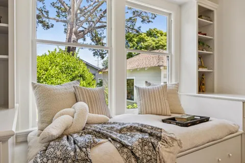 a bedroom with bed and a window