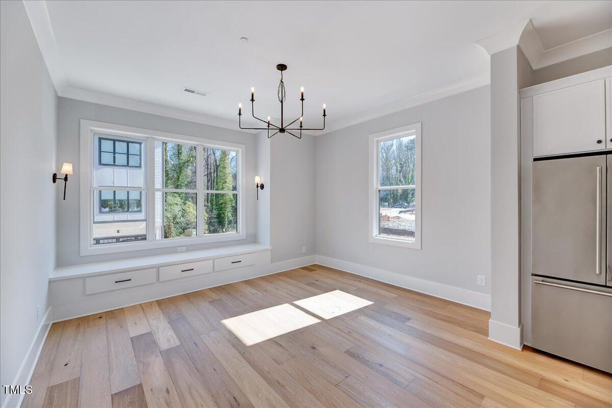 811 Maple Berry Lane, Unit 106 Raleigh, NC 27607 - Photo 5 of 30 a view of empty room with wooden floor and fan