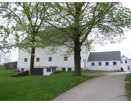 235 Lions Mouth Road Amesbury, MA 01913 - Photo 3 of 12 a white house with a big yard and large trees