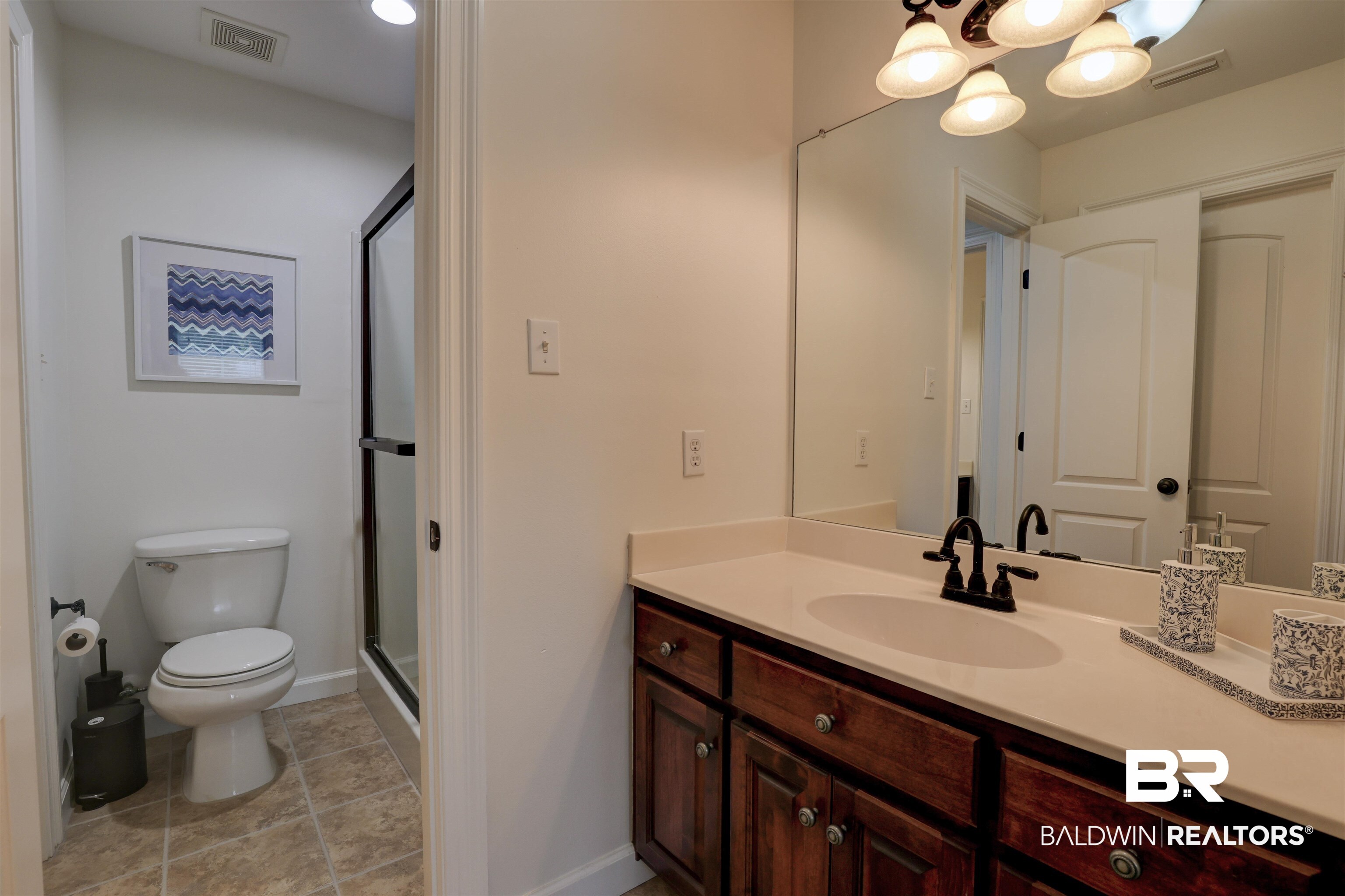 5565 Dawes Lane Theodore, AL 36582 - Photo 22 of 38 Bathroom with vanity, toilet, a shower with shower door, and tile patterned floors