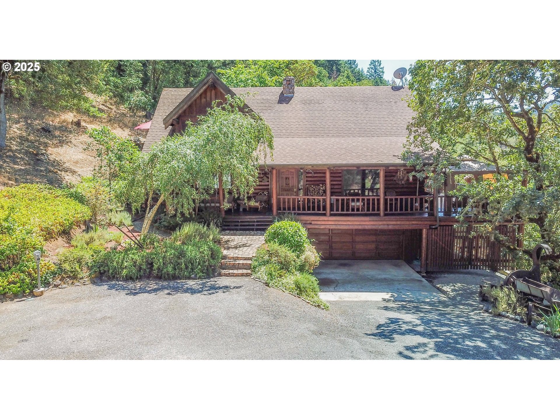 1138 Yokum Road Riddle, OR 97469 - Photo 2 of 33 a backyard of a house with plants and outdoor seating