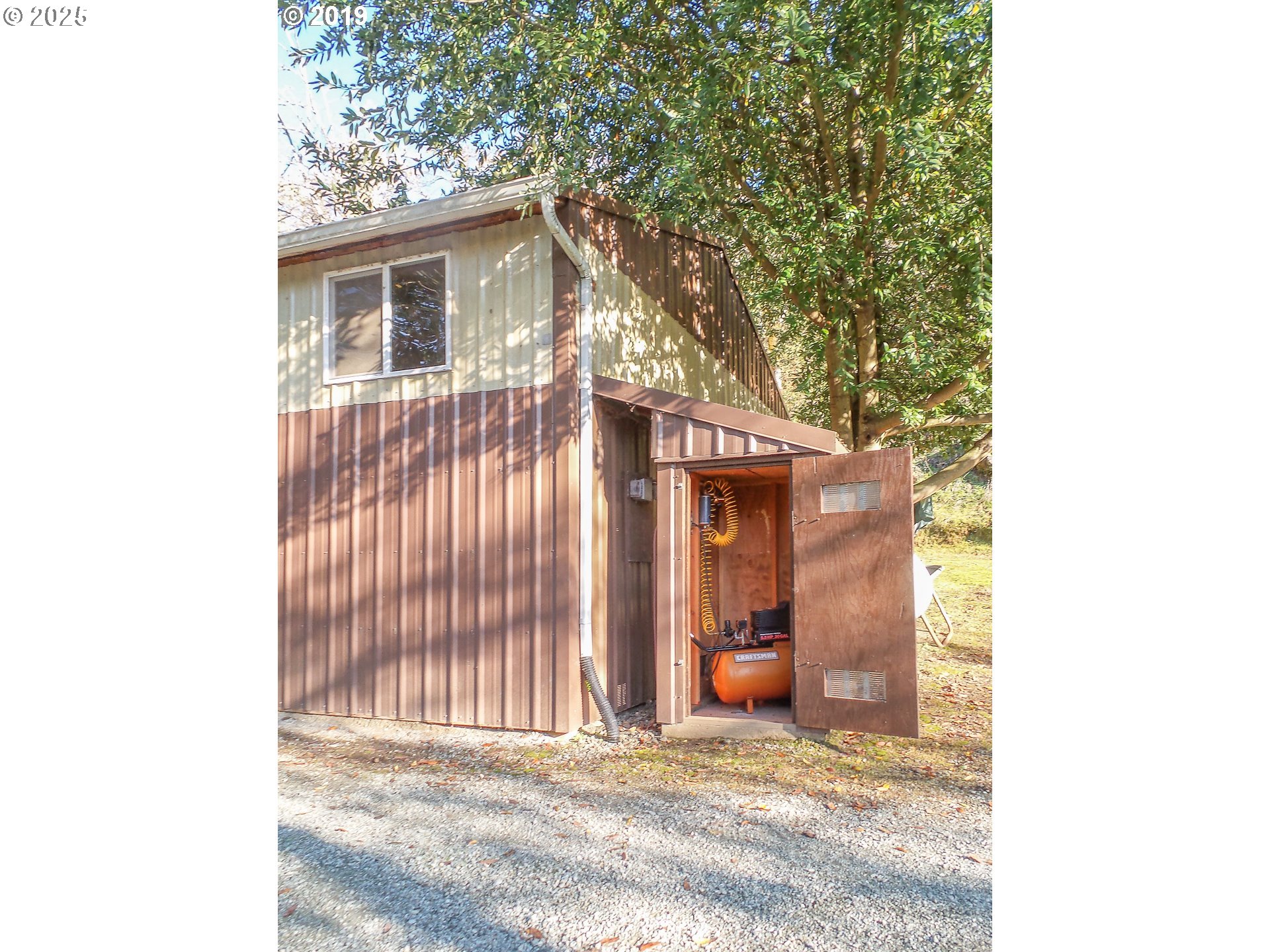 1138 Yokum Road Riddle, OR 97469 - Photo 21 of 33 a view of a house with a large tree and wooden fence