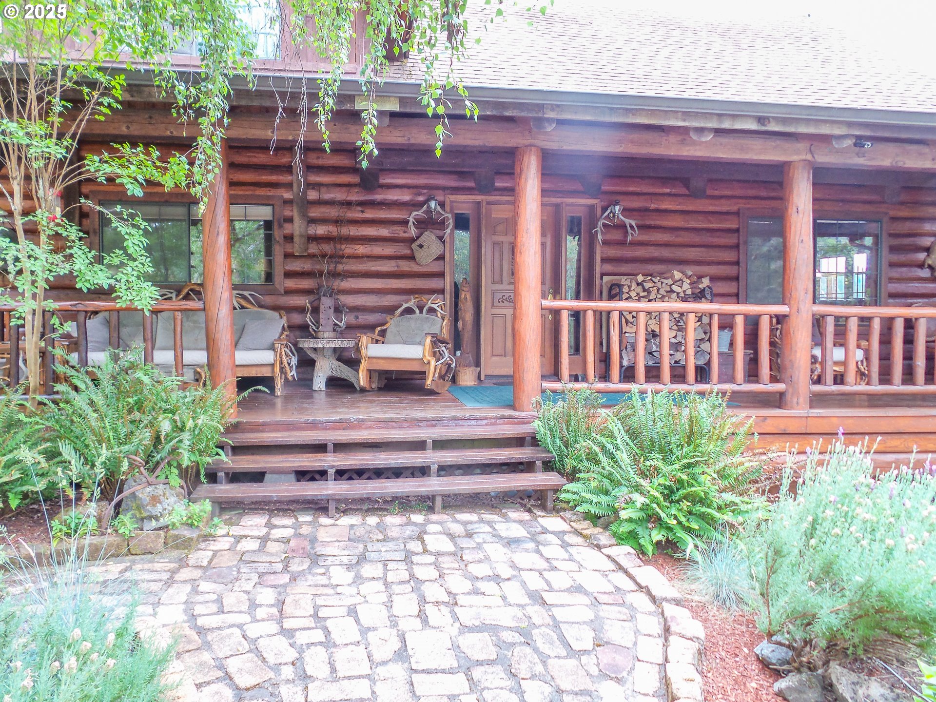 1138 Yokum Road Riddle, OR 97469 - Photo 3 of 33 a view of a patio with chairs and potted plants