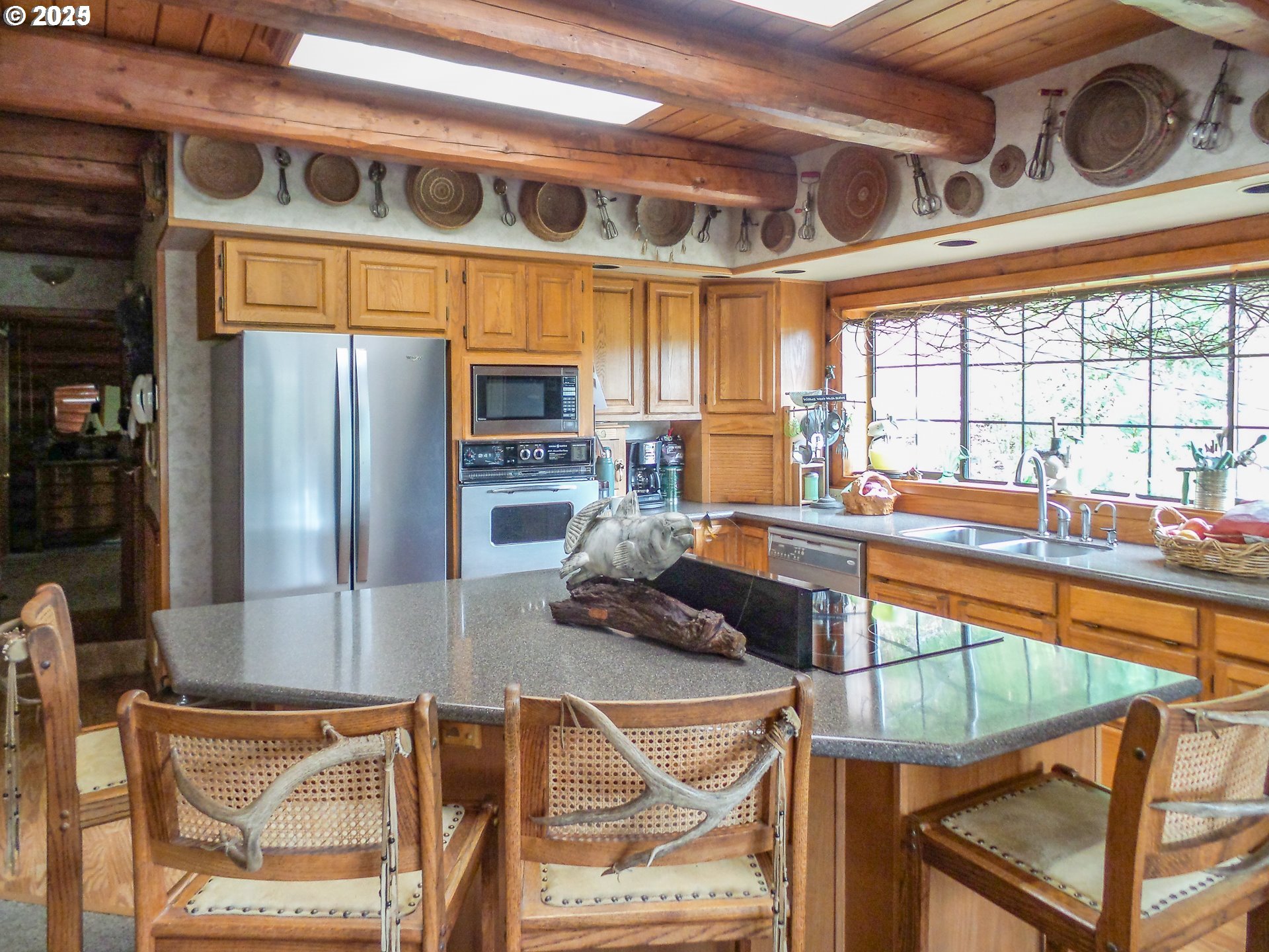 1138 Yokum Road Riddle, OR 97469 - Photo 9 of 33 a kitchen with stainless steel appliances granite countertop a sink and a refrigerator