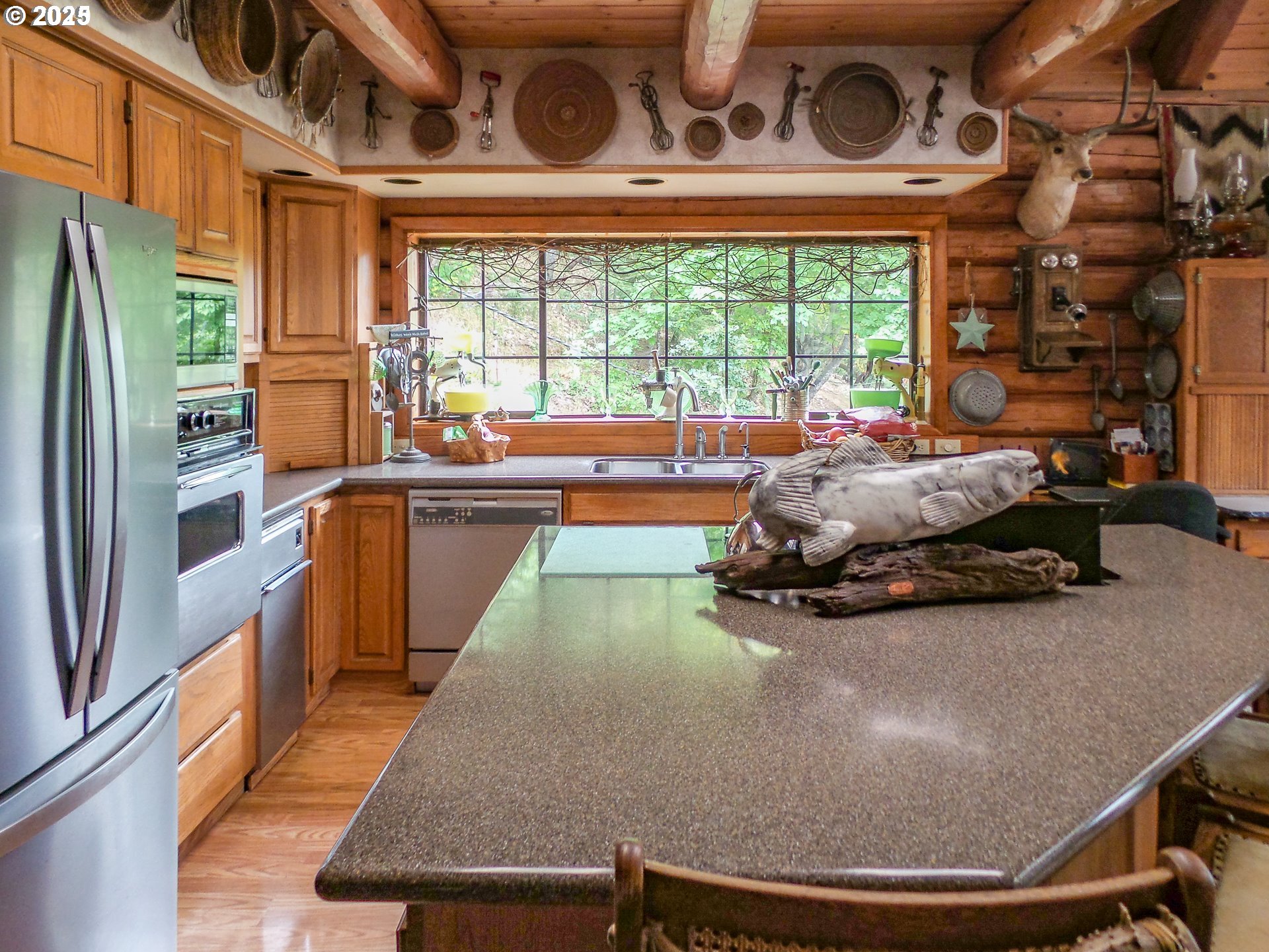 1138 Yokum Road Riddle, OR 97469 - Photo 10 of 33 a room with a bed and a large window