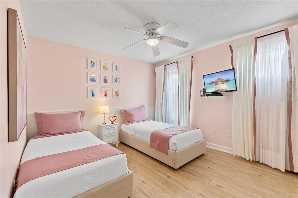 9006 Majesty Palm Road Kissimmee, FL 34747 - Photo 46 of 56 a bedroom with two beds and painting on the wall