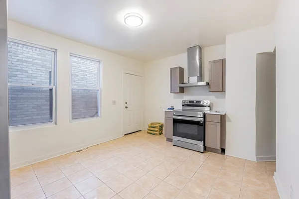a kitchen with a stove and a refrigerator