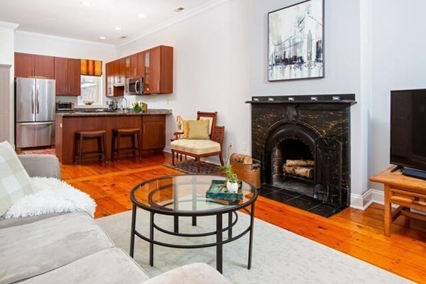 39 Mt Vernon Street, Unit 2 Boston, MA 02129 - Photo 1 of 9 a living room with furniture a fireplace and a flat screen tv