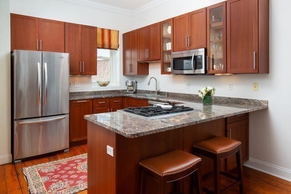39 Mt Vernon Street, Unit 2 Boston, MA 02129 - Photo 3 of 9 a kitchen with stainless steel appliances granite countertop a stove refrigerator sink and microwave