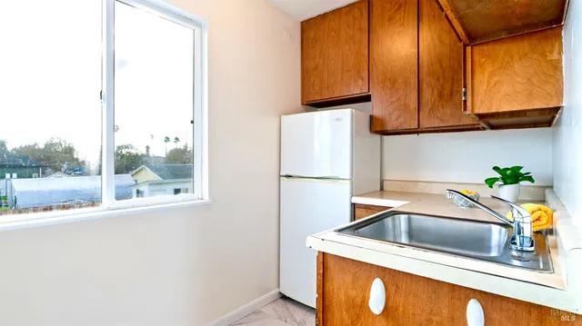 a kitchen with stainless steel appliances granite countertop a sink and a microwave