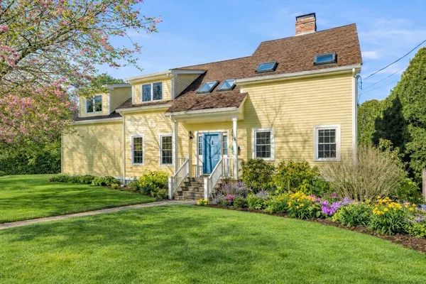 a front view of a house with garden