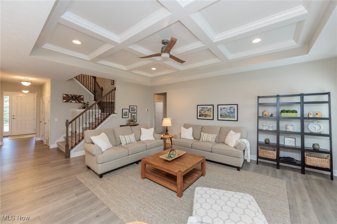 2041 Jaycox Road Avon, OH 44011 - Photo 13 of 50 Living area featuring light wood-style floors, recessed lighting, coffered ceiling, stairs, and beam ceiling