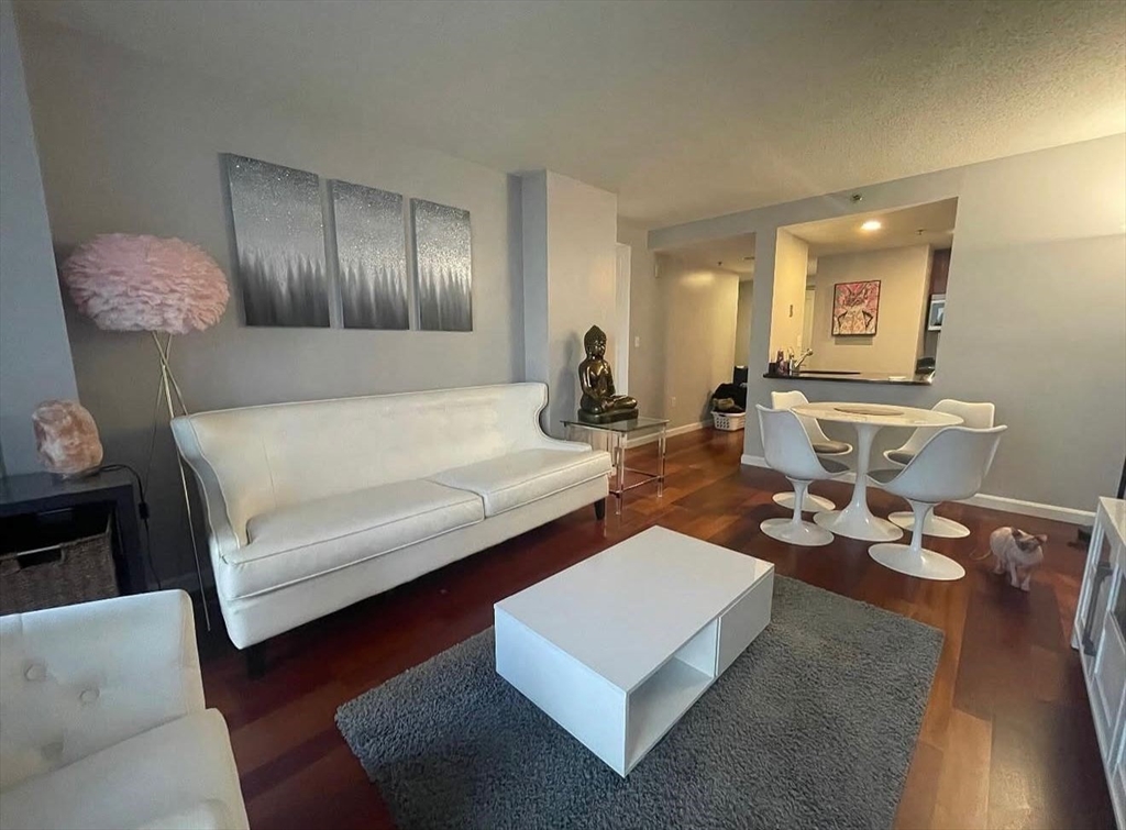 10 Museum Way, Unit 528 Cambridge, MA 02141 - Photo 3 of 10 a living room with furniture and wooden floor