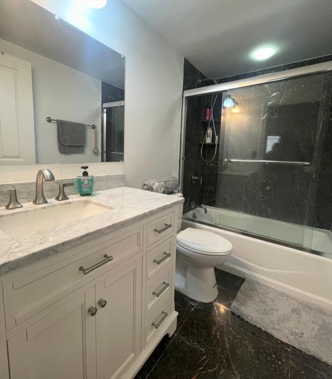 10 Museum Way, Unit 528 Cambridge, MA 02141 - Photo 5 of 10 a bathroom with a double vanity sink toilet mirror and shower