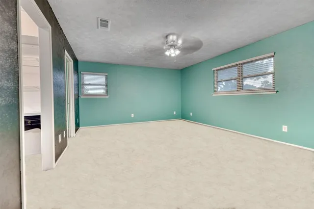 a view of a room with a large bed