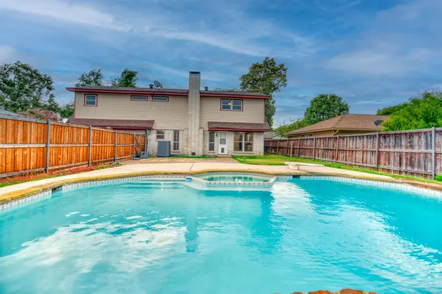 a view of a swimming pool with a patio
