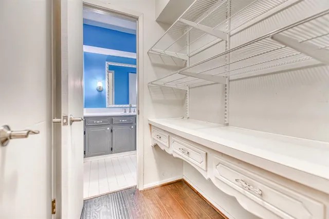 a view of a walk in closet and wooden floor